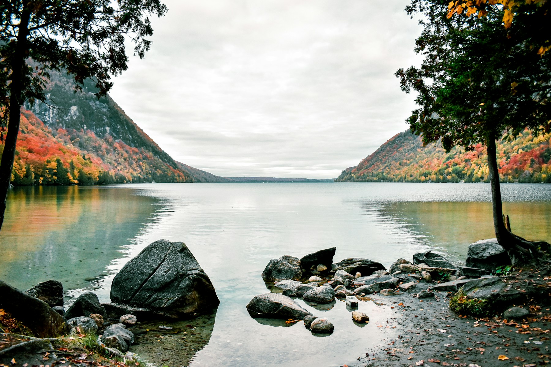 Autumn foliage and mountain slopes reflected in a Vermont lake
